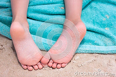 Little girl feet on a beach towel Stock Photo