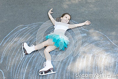 Little girl figure skating at imaginary skating rink arena Stock Photo