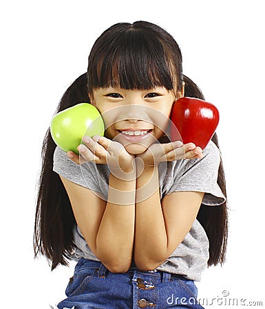 A little girl flexes her muscle while showing off the apple that made her strong and healthy Stock Photo