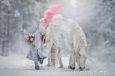 Little girl with with flowers bouquet and white horse Stock Photo