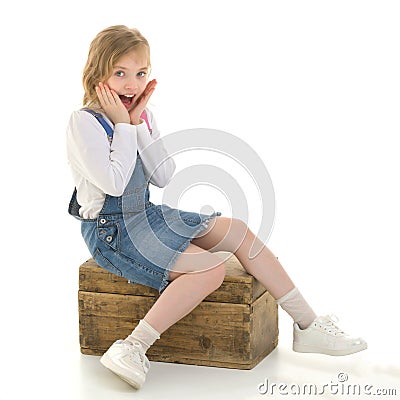 The little girl folded her hands around her face. Stock Photo