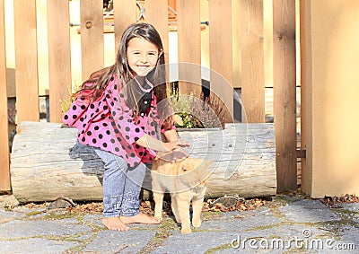 Little girl stroking a cat Stock Photo