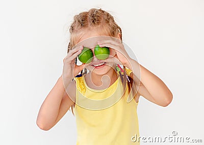 Little girl with fresh lime fruits Stock Photo