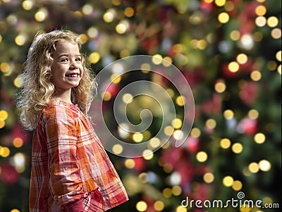 Little girl in front of a chrismas tree Stock Photo