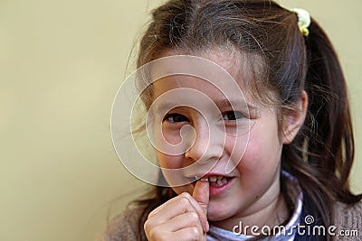 Little girl with the front tooth dangles Stock Photo