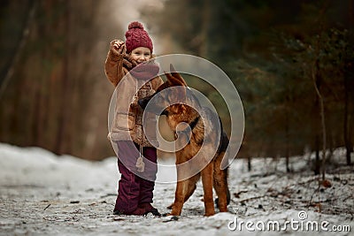 Little girl with German shepherd 6-th months puppy at early spring Stock Photo