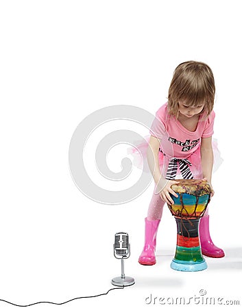 Little girl going to play on Djembe Stock Photo