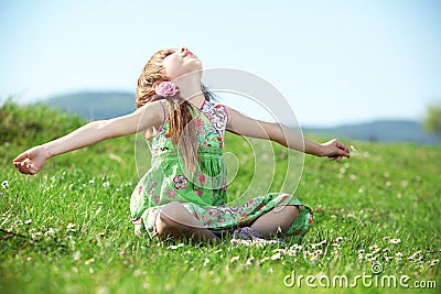 Little girl at green field Stock Photo