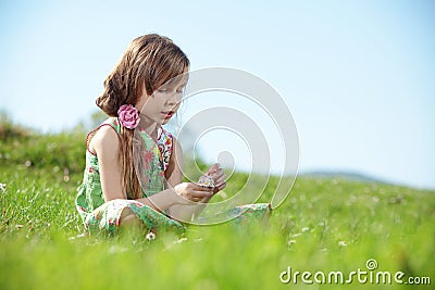 Little girl at green field Stock Photo