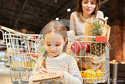 Little Girl Grocery Shopping with Mom Stock Photo