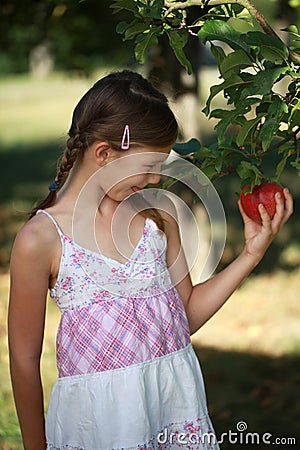 Little girl having an appetite for an apple Stock Photo