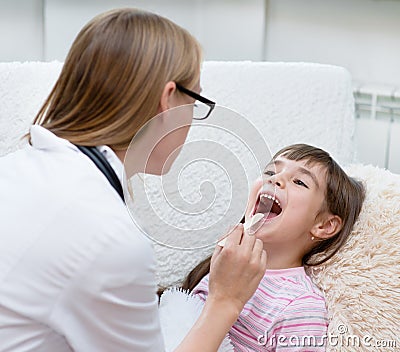 Little girl having his throat examined by health professional Stock Photo