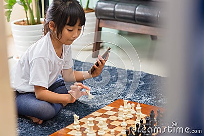 Little girl having online chess lesson, e-education, distance learning Stock Photo