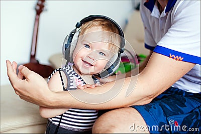 The little girl in headphones, smiling Stock Photo