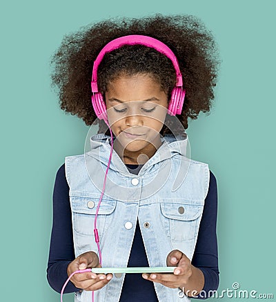 Little Girl Headphones Using Phone Stock Photo