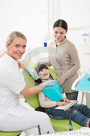 Little girl with her mother at dentist's office Stock Photo