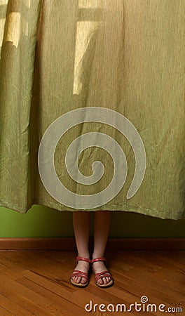 Little girl hid behind the curtain Stock Photo