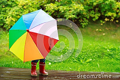 Little girl hiding behind umbrella Stock Photo