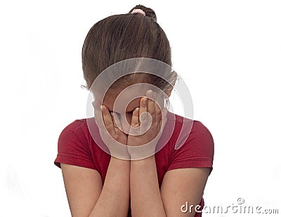 Little girl hiding her face with her hands Stock Photo