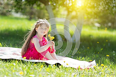 A little girl is holding a bouquet of flowers. Stock Photo