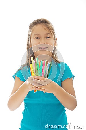 Little girl holding crayons Stock Photo