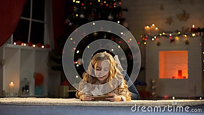 Little girl holding envelope with letter for Santa, belief in X-mas magic Stock Photo