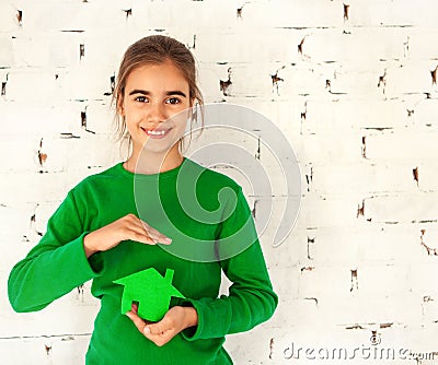 Little girl holding green house in hands Stock Photo