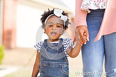 Little girl holding her mothers hand. Stock Photo