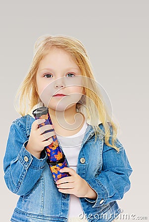 Little girl holding a kaleidoscope. Stock Photo