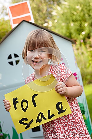 Little Girl Holding For Sale Sign Outside Play House Stock Photo