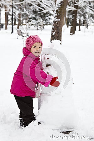 Little girl holding a snowman Stock Photo