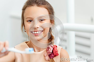 Little girl holding Teeh Brush. Happy girl brushing her teeth Stock Photo