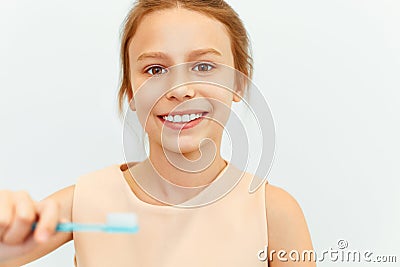 Little girl holding Teeh Brush. Happy girl brushing her teeth Stock Photo