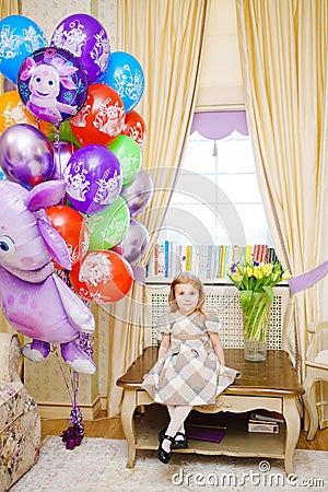 little girl at home with balloons. Inflatable hero of the Russian cartoon Luntik Editorial Stock Photo