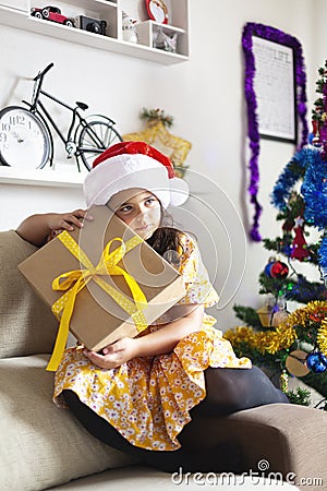 Little girl at home with gift from Santa Claus. Christmas time Stock Photo