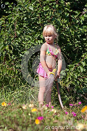 Little girl with hosepipe Stock Photo
