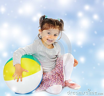 Little girl hugging a big ball Stock Photo