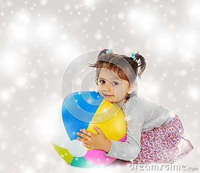 Little girl hugging a big ball Stock Photo