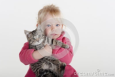 Little girl hugging pet kitten Stock Photo