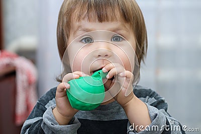 Little girl intend to blow up ball Stock Photo