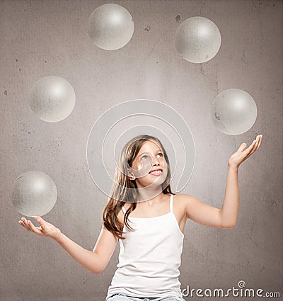 Little girl juggling with crystal sphere balls Stock Photo