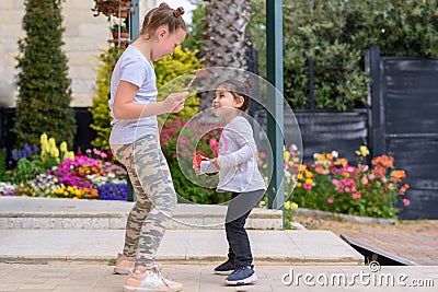 Little Girl Jumping, Dancing, Having Fun Outdoor. Happy Summer Vacation. Stock Photo