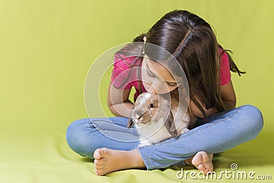Little girl kissing her pet rabbit Stock Photo