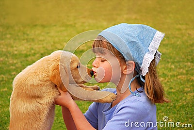 Little girl kissing her puppy Stock Photo