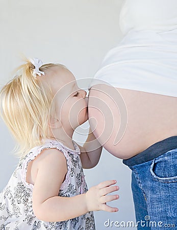 Little Girl Kissing Mom Stock Photo