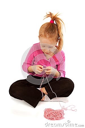 Little girl knitting Stock Photo