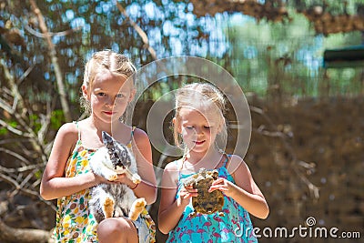 Little girl with a land tortoise and cute rabbit Stock Photo