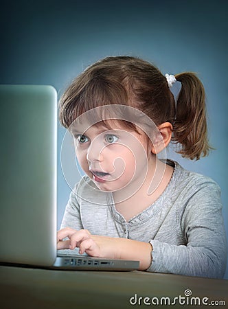 Little girl with laptop Stock Photo