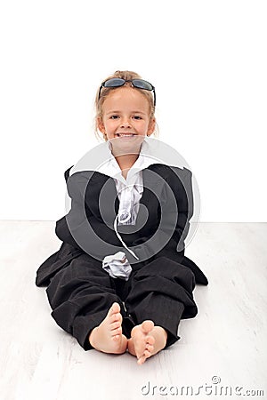 Little girl in large business clothes Stock Photo