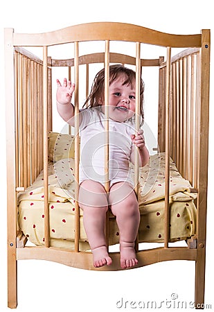 Little girl laughing sitting in bed Stock Photo
